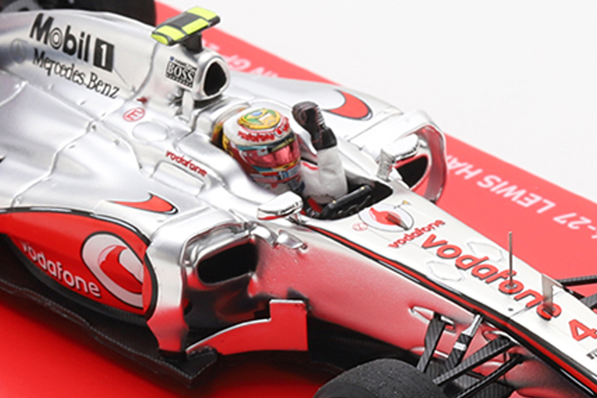 The figure depicts Hamilton wearing a special helmet and striking a triumphant fist-pump pose.